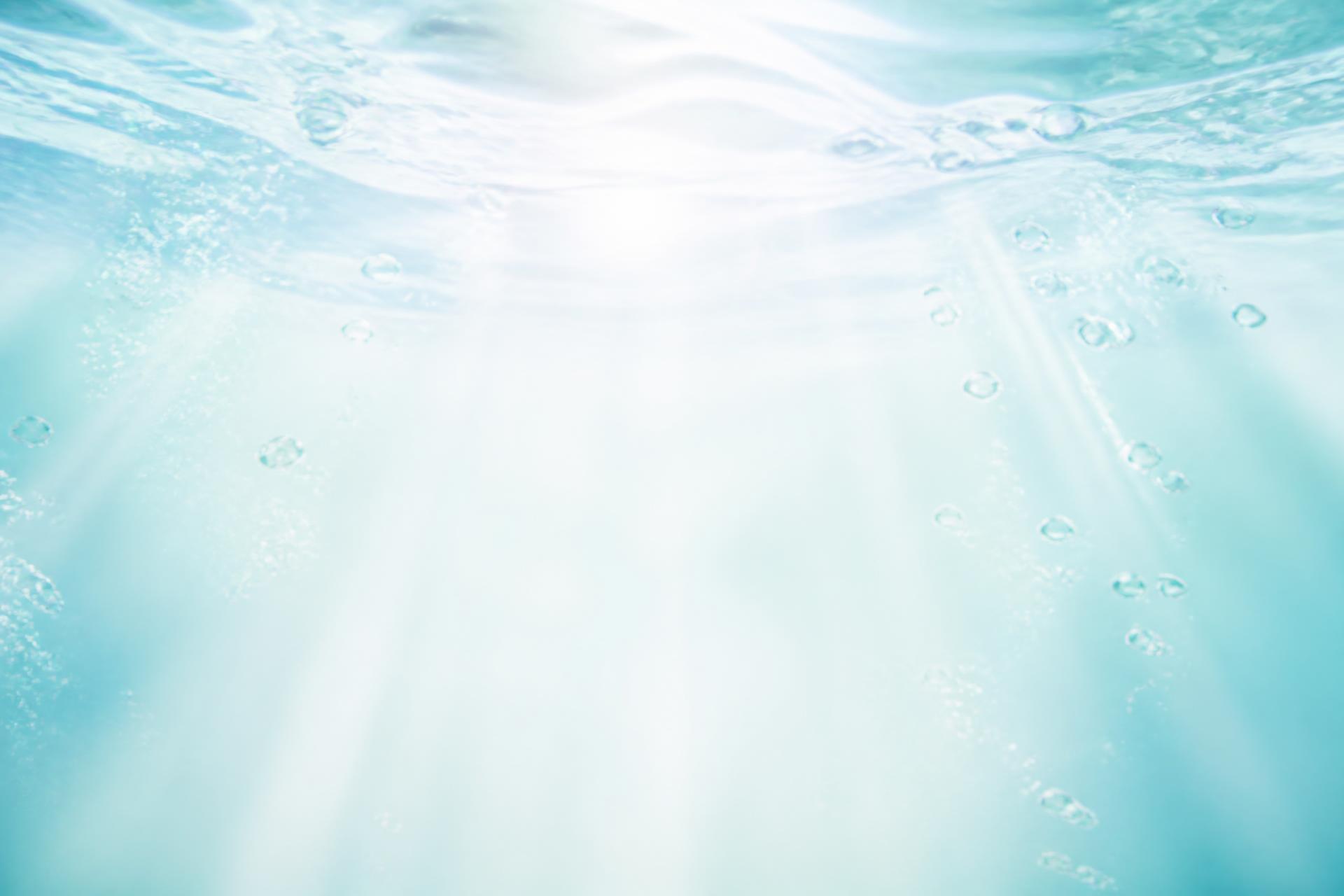 Sunlight and oxygen bubbles rising through clear fresh water